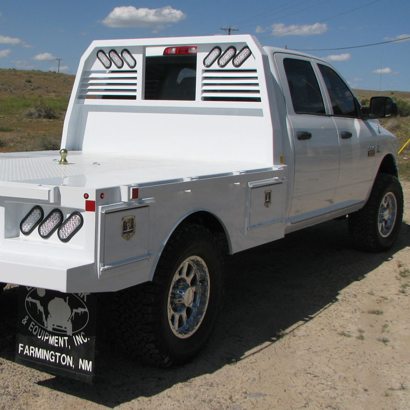 Largo custom flatbed truck body with headache rack on a white pickup chassis